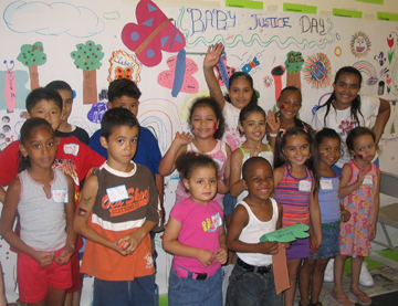 Photograph of kids posing for a picture: involved in a community oriented environmental justice project