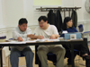 Minkyu, Caleb, and Rebecca at the Service Table