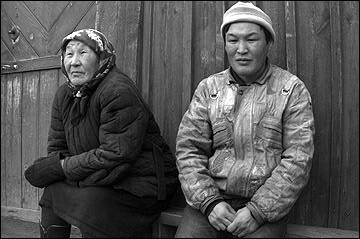 Bakhar & Zhargat sitting outside their home in Galtai