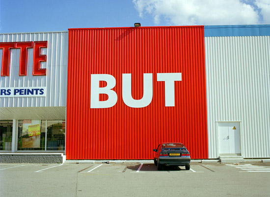 Andrea Robbins and Max Becher, BUT: American in France, Strip Malls of Toulouse, 2003. Chromogenic print.
