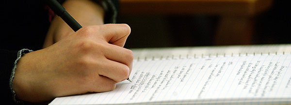 A student taking notes in class.