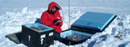 Michael Studinger, a scientist with the Lamont-Doherty Earth Observatory, conducts research activities near the Vostok Station in Antarctica.