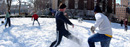 Columbia students play soccer in the snow.