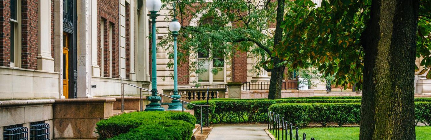 Sidewalks wind between the lush lawns surrounding Philosophy and Kent Halls on the Columbia University Morningside campus.