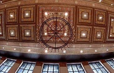 Ornate ceiling decorated with a chandelier and brown tiles