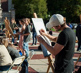 A man draws on a canvas