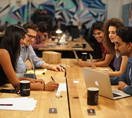 People at a table with laptops