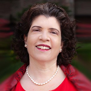 Jeanine D'Armiento, a woman with dark hair in a red outfit. 