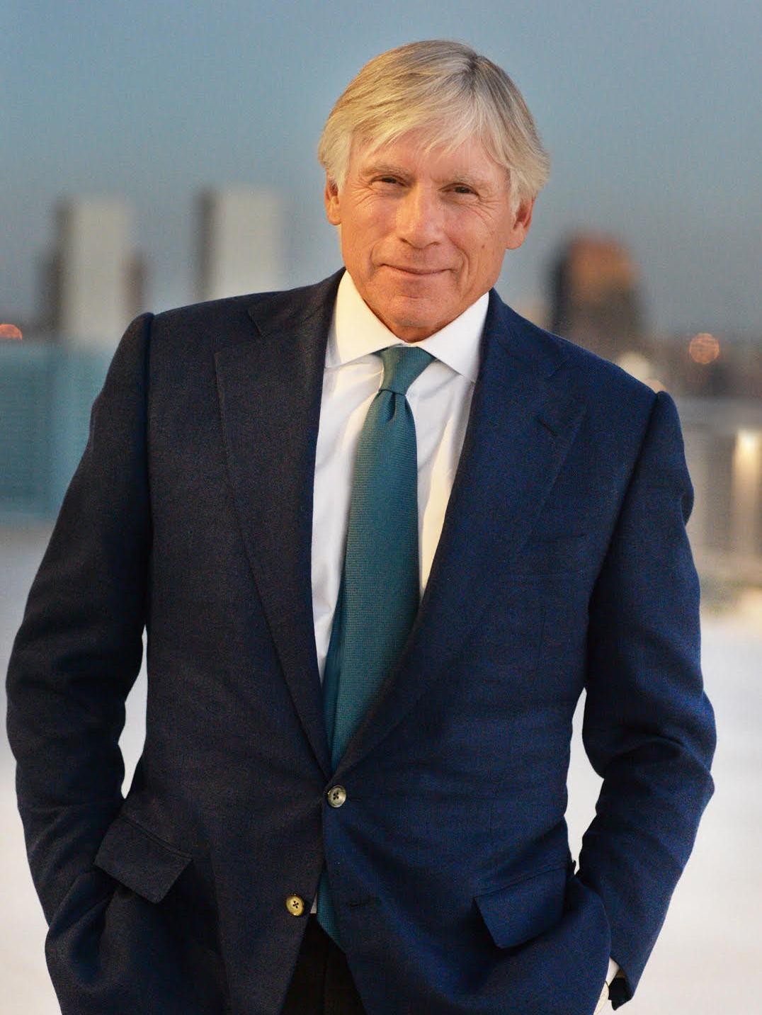 Columbia University President Lee C. Bollinger wearing a dark blue sports jacket and tie