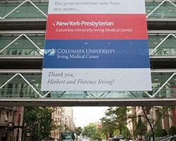 Red, blue and white banner hanging over a glass building