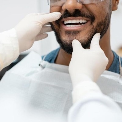 A person gets their mouth checked by a doctor