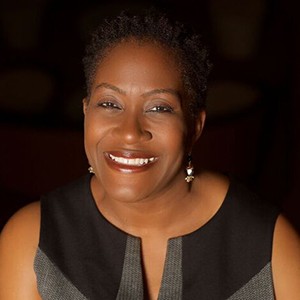 Wanda M. Holland Greene, a woman with short dark hair, smiling. 