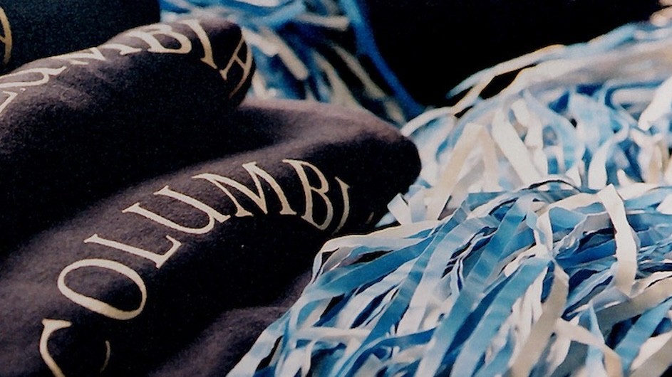 Columbia blue and white sweatshirts and pom-poms