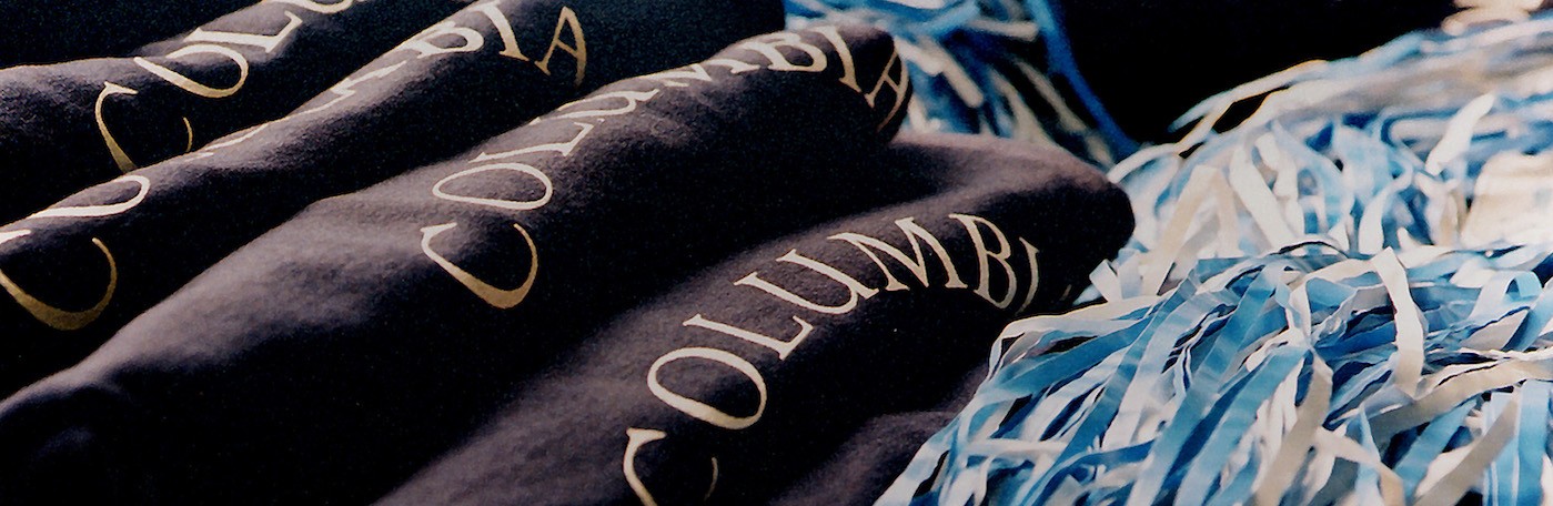 Columbia University school spirit sweatshirts and blue and pom-poms.