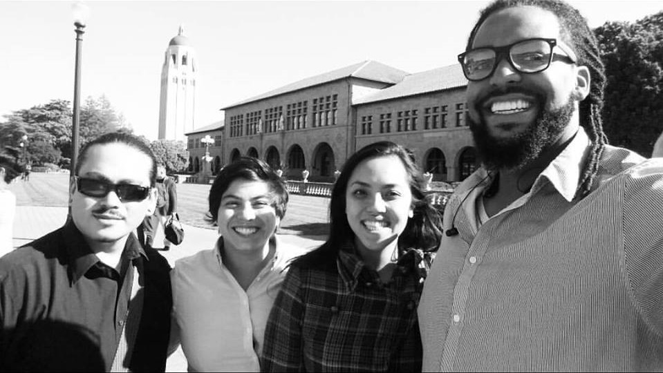 smiling team members pose for photo.